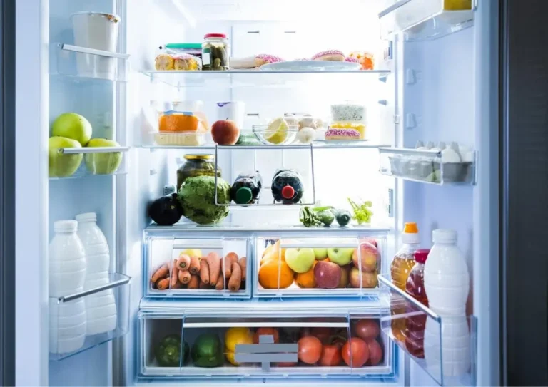 Open refrigerator filled with fresh food